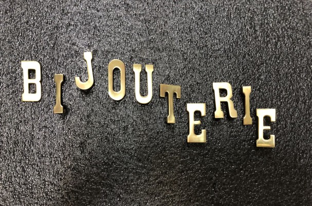 Old small letters jewelry store sign.